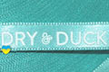Брендированная лента с печатью логотипа нанесенным вспененой краской для компании Duck Dry, цвет ленты - бирюза (номер ленты 122), цвет краски - белый, ширина ленты - 10 мм, город Лондон.